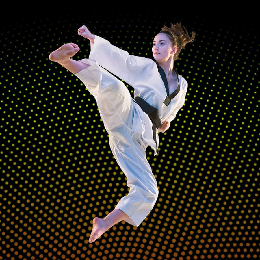 Martial Arts Lessons for Adults in Roy UT - Girl Black Belt Jumping High Kick